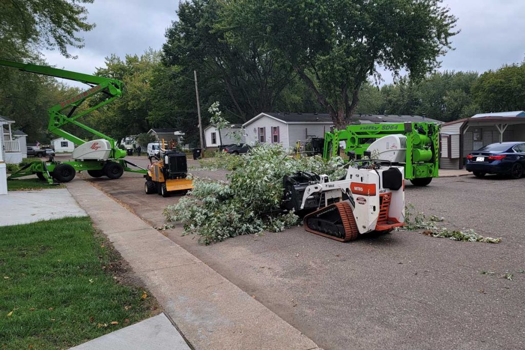 Tree trimming equipment clearing branches on residential street
